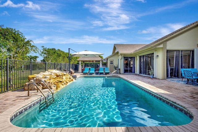 view of swimming pool featuring a gazebo, a patio, and pool water feature