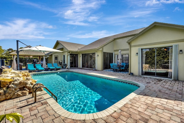 view of swimming pool with a gazebo and a patio area