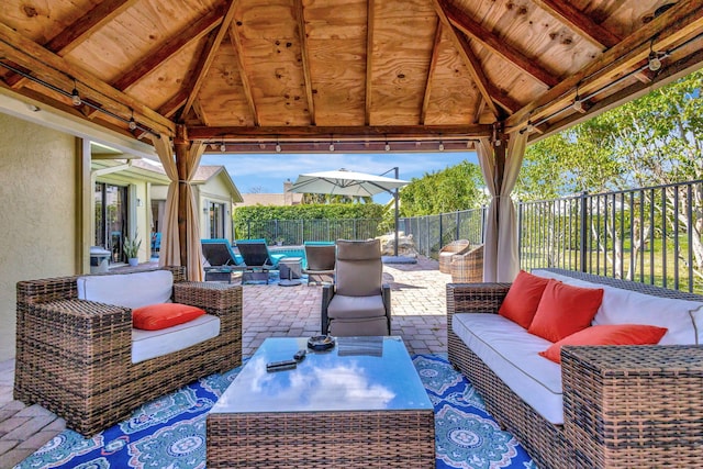 view of patio / terrace with a gazebo, an outdoor hangout area, and a fenced in pool