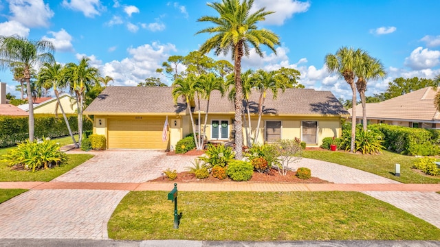 view of front of house featuring a garage and a front lawn