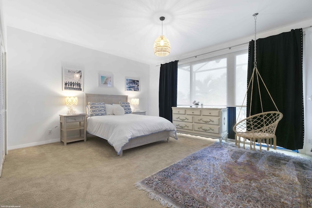 bedroom with light carpet and baseboards