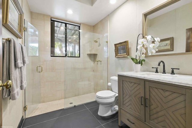 full bathroom featuring toilet, a stall shower, tile patterned flooring, and vanity