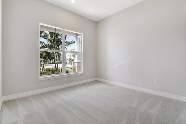 spare room featuring recessed lighting, carpet flooring, and baseboards