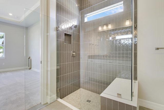 bathroom with recessed lighting, tiled shower, and baseboards