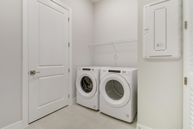 laundry room featuring laundry area, baseboards, and washing machine and clothes dryer