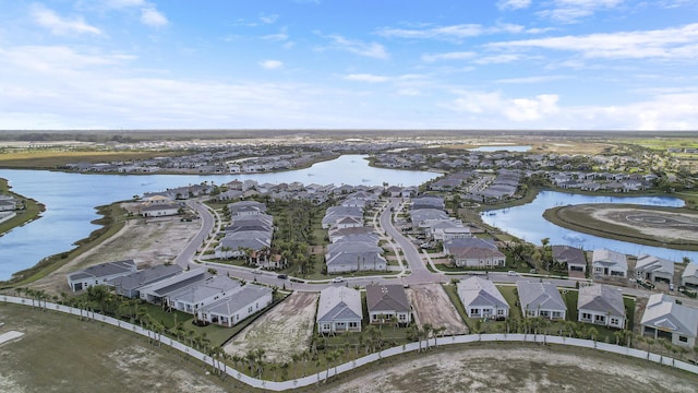 bird's eye view featuring a water view and a residential view