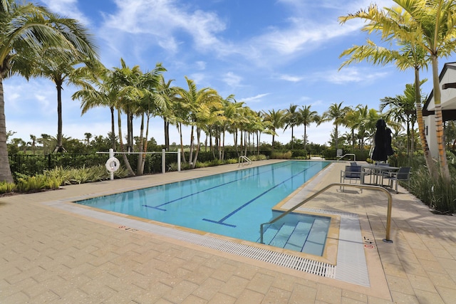 community pool featuring a patio and fence