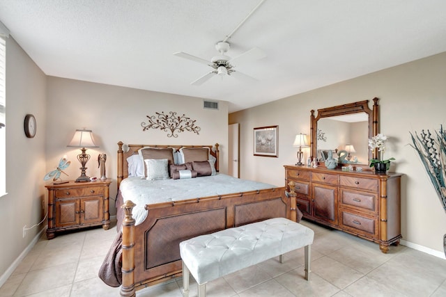 bedroom featuring light tile patterned floors, baseboards, visible vents, and ceiling fan