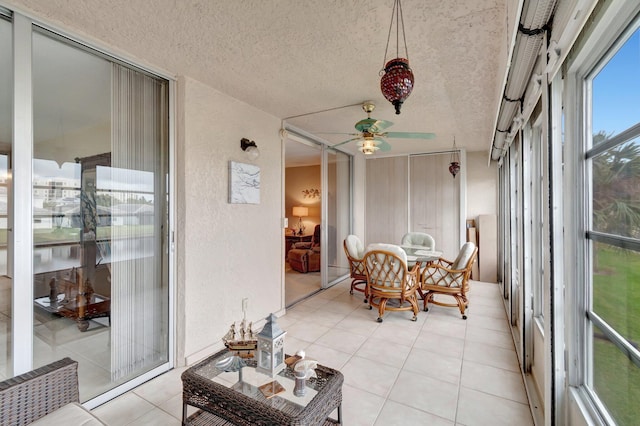 sunroom featuring a ceiling fan