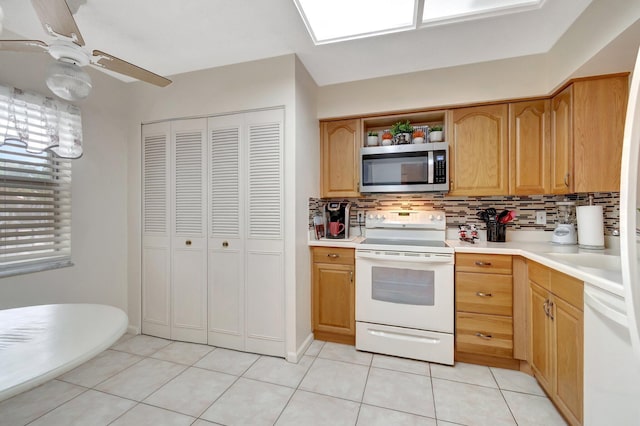 kitchen featuring light countertops, white appliances, and tasteful backsplash