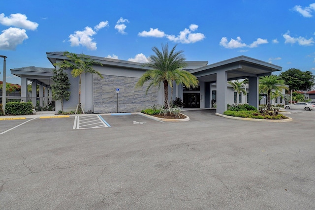 view of building exterior with uncovered parking