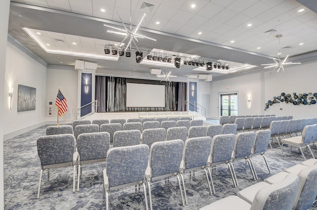 home theater room featuring visible vents, a raised ceiling, and recessed lighting