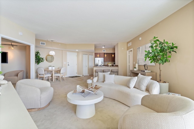 living room with light carpet and visible vents