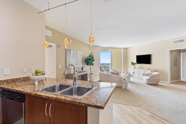 kitchen with visible vents, dishwasher, open floor plan, hanging light fixtures, and a sink