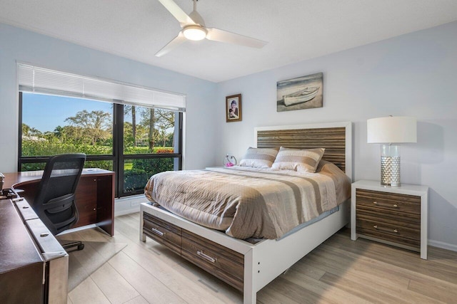 bedroom with ceiling fan and light wood-type flooring