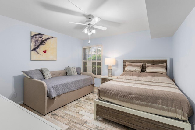 bedroom with ceiling fan and light hardwood / wood-style flooring