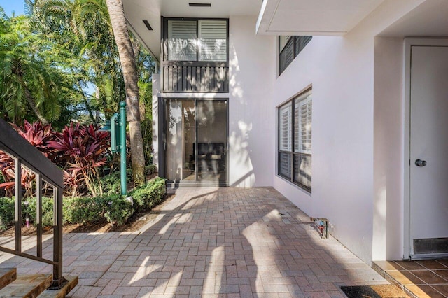 view of exterior entry featuring a patio area