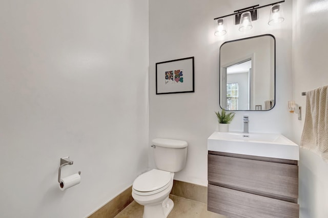 bathroom featuring vanity, tile patterned floors, and toilet