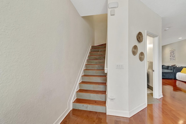 stairs with wood-type flooring
