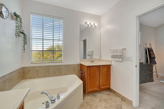 bathroom with vanity, a washtub, and tile patterned flooring