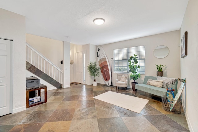 foyer entrance with a textured ceiling