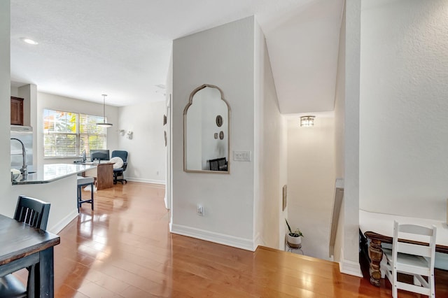 corridor with light hardwood / wood-style floors