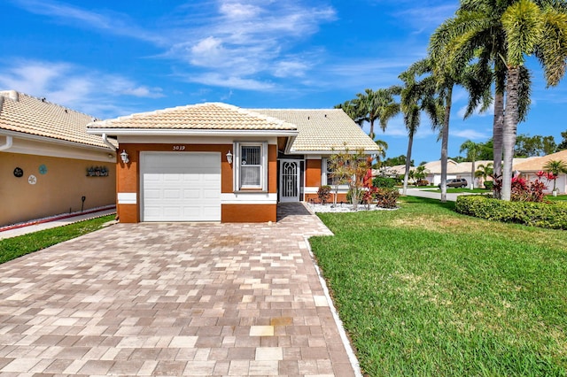 view of front facade with a front yard and a garage