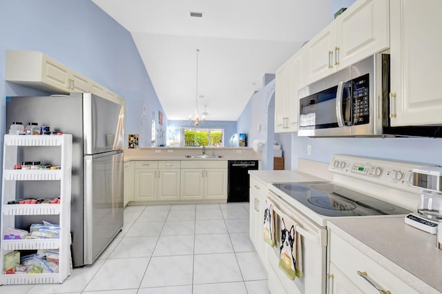 kitchen with appliances with stainless steel finishes, decorative light fixtures, a chandelier, light tile patterned floors, and sink