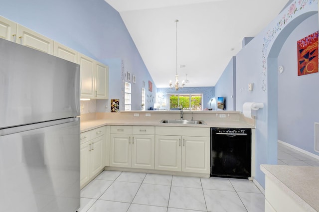 kitchen featuring sink, black dishwasher, light tile patterned flooring, decorative light fixtures, and stainless steel fridge