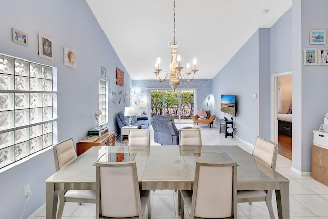 tiled dining space featuring high vaulted ceiling and a notable chandelier