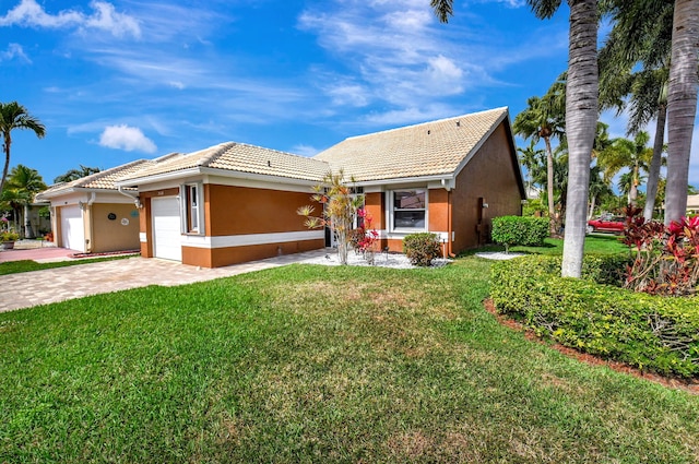 view of front of property featuring a garage and a front lawn