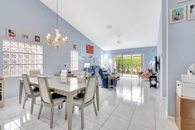 tiled dining room featuring ceiling fan with notable chandelier and high vaulted ceiling