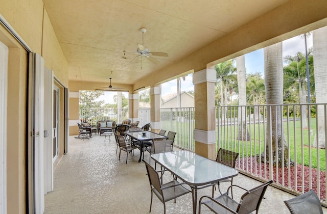 sunroom / solarium featuring ceiling fan