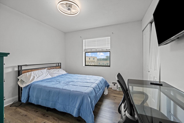 bedroom with dark hardwood / wood-style flooring