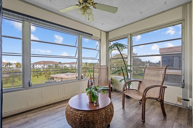 sunroom / solarium featuring ceiling fan