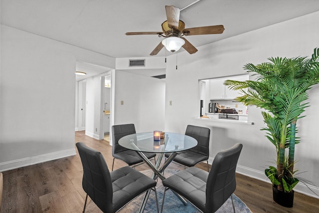 dining space with dark hardwood / wood-style floors and ceiling fan