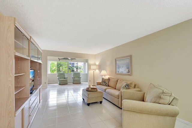 living room featuring a textured ceiling and light tile patterned floors