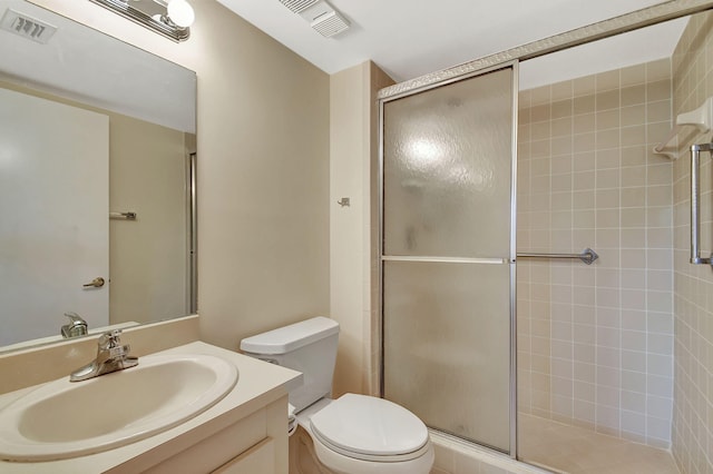 bathroom with a shower with door, vanity, and toilet