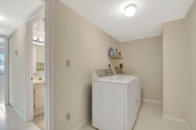 clothes washing area with light tile patterned floors and independent washer and dryer