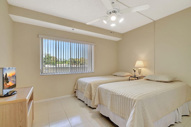 bedroom with light tile patterned flooring and ceiling fan