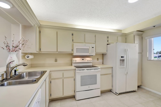 kitchen with cream cabinets, sink, a textured ceiling, and white appliances