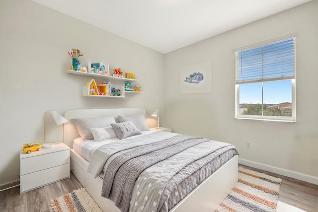 12521 NW Lynch Ln, Port Saint Lucie, FL 34987 - bedroom featuring baseboards and wood finished floors