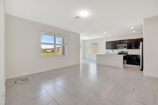 interior space featuring recessed lighting, light tile patterned flooring, visible vents, and baseboards