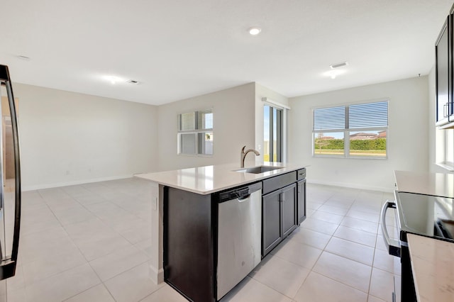 kitchen featuring black range with electric cooktop, a sink, light countertops, stainless steel dishwasher, and a wealth of natural light