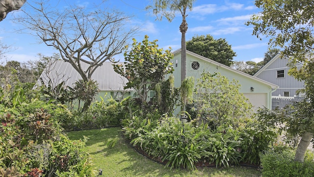 view of property exterior featuring a yard and an attached garage