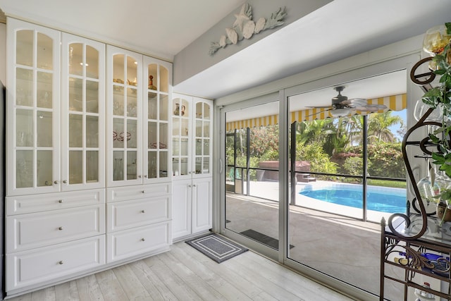 10174 Dogwood Ave, Palm Beach Gardens, FL 33410 - doorway to outside featuring a ceiling fan, plenty of natural light, and light wood finished floors