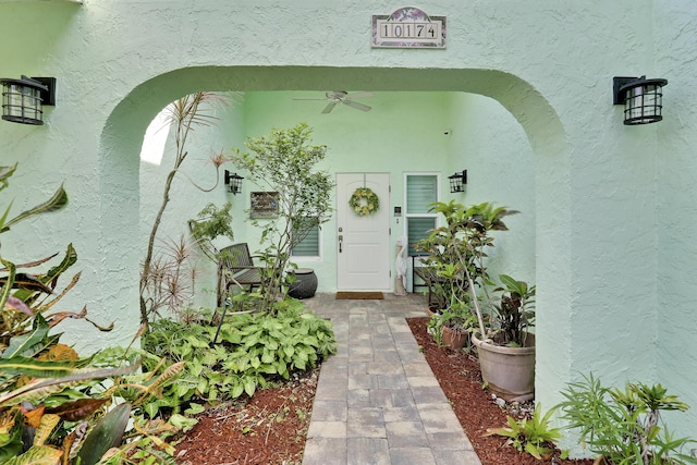 10174 Dogwood Ave, Palm Beach Gardens, FL 33410 - view of exterior entry with ceiling fan and stucco siding