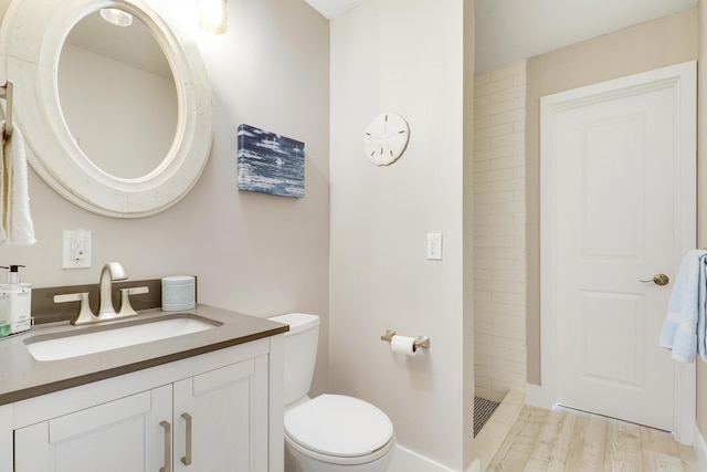 10174 Dogwood Ave, Palm Beach Gardens, FL 33410 - full bathroom with a stall shower, toilet, vanity, and wood finished floors