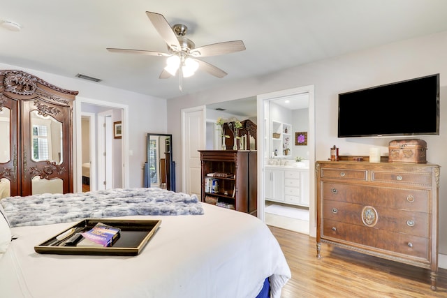 10174 Dogwood Ave, Palm Beach Gardens, FL 33410 - bedroom featuring wood finished floors, ensuite bath, french doors, a ceiling fan, and a sink
