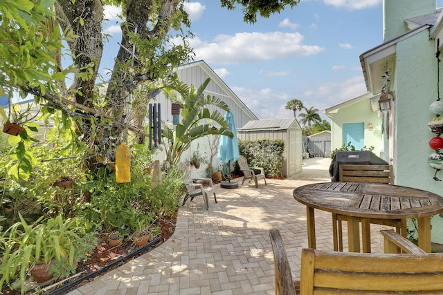 10174 Dogwood Ave, Palm Beach Gardens, FL 33410 - view of patio with a storage shed, grilling area, an outdoor structure, and fence